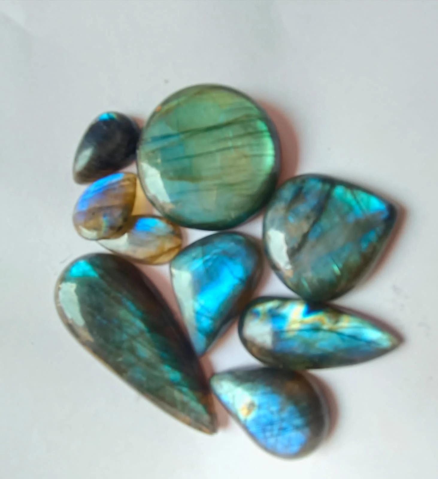Multi-Flash Labradorite cabochons reflecting blue, green and golden colour
